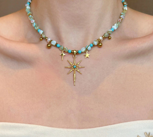 Celestial Tide – Turquoise-Tone Beaded Necklace with Gold-Tone Starburst Pendant